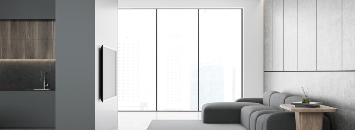 Schicke Wohnung mit grauen Möbeln und grauen Wänden und Böden AdobeStock_301784853